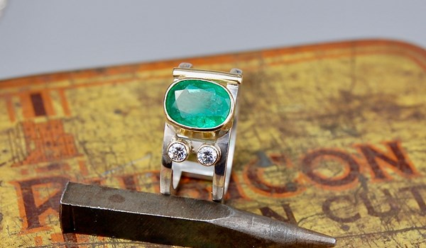 Emerald and diamonds set in 18ct gold on silver ring